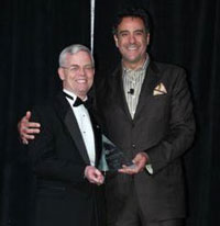 Deputy Under Secretary for Health for Operations and Management William Schoenhard accepts the 2011 Global Vision Award from Master of Ceremonies Brad Garrett