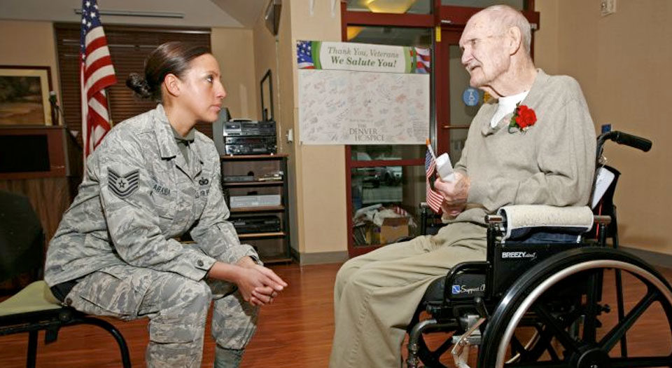 Young vet talk to older vet who is in a wheelchair