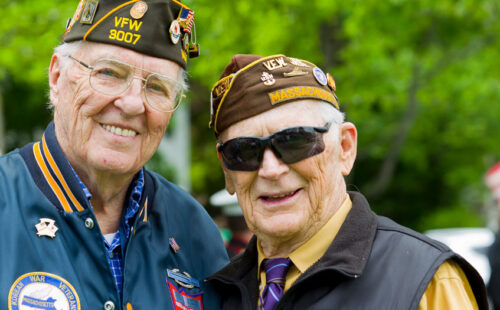Two vets from a local VFW. They are smiling.