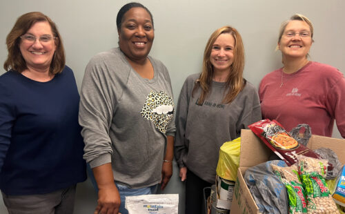 Four hospice staff members drop of donations