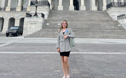 Abby Sauer standing in front of the US Capitol building.
